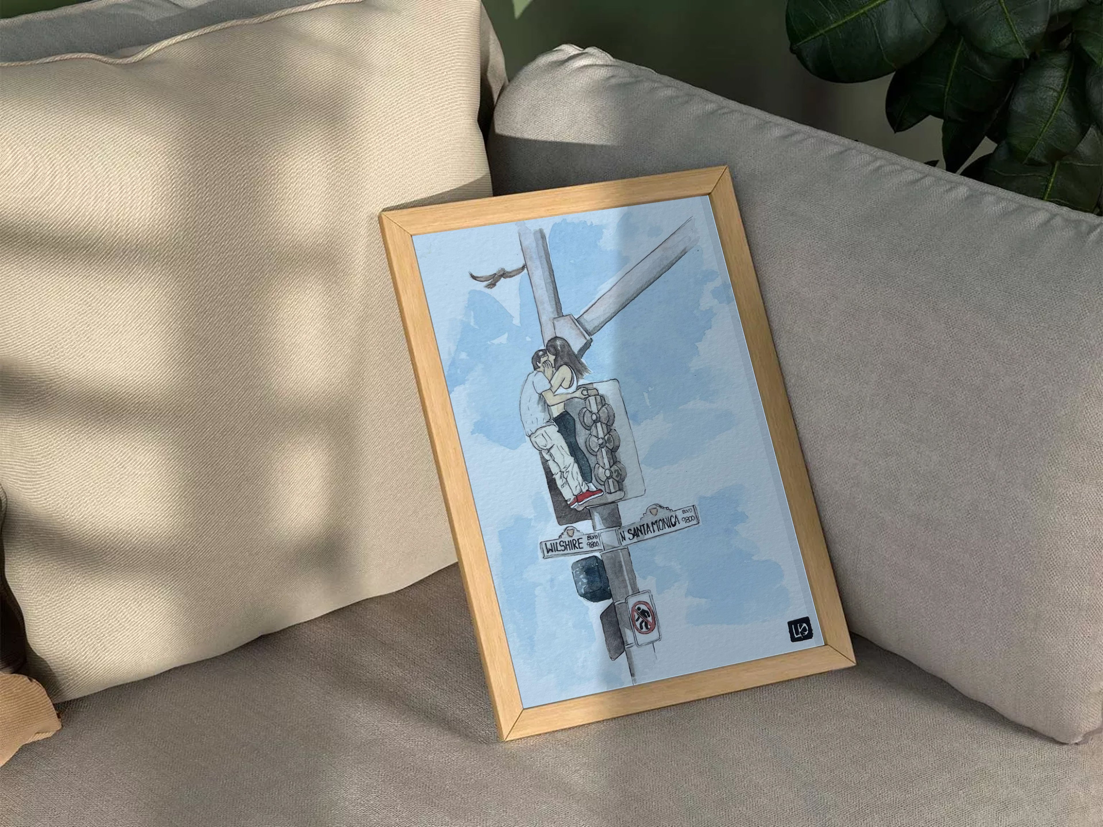 Framed artwork of a streetlight scene on a couch